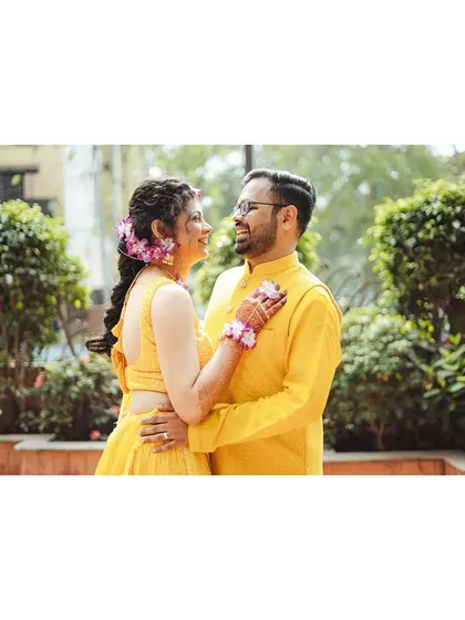 Mithila and Sagar share a look of love during their Haldi ceremony. Dressed in vibrant yellow, their connection shines through in this happy, candid portrait.