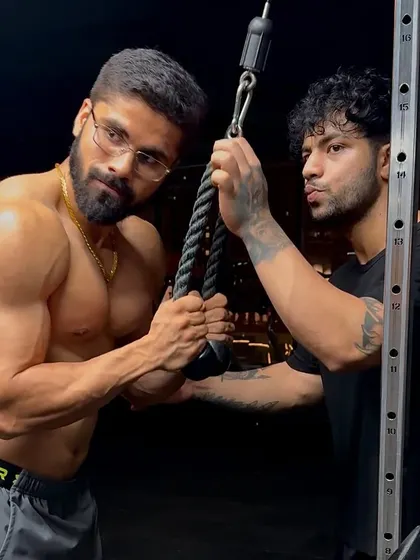 In the gym, making sure the form is perfect for tricep pushdowns. Every detail matters when you're aiming for a top-tier physique.