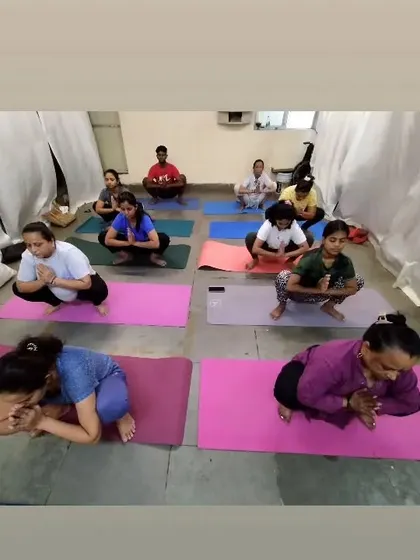 A group of students practicing Malasana, or the Garland Pose. This deep squat is excellent for opening the hips and grounding our energy, and we often hold it to find stillness.