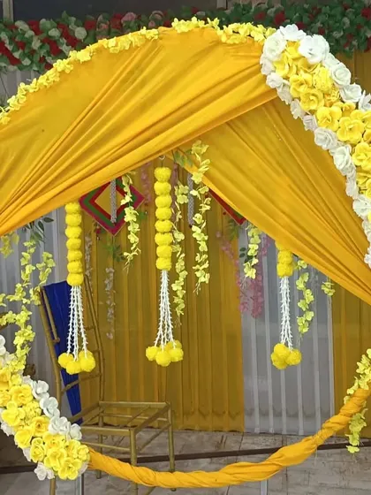 Another angle of the draped ring backdrop, highlighting the hanging floral tassels. We pay attention to every detail to create a perfect and memorable setup.