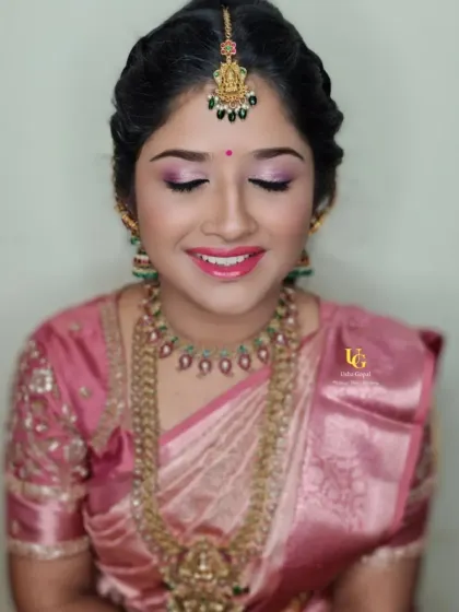 Deepthi with her eyes gently closed, highlighting the beautiful pink and shimmer eyeshadow work for her event makeup.