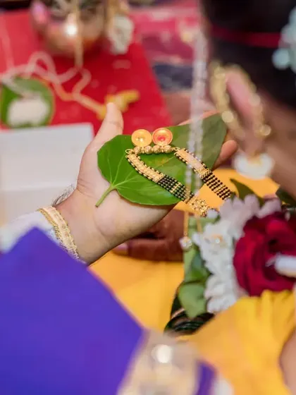 A symbolic shot of the mangalsutra resting on a betel leaf before being presented to the bride.