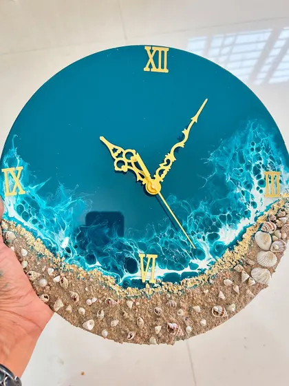 A classic beach-themed clock with realistic waves, a sandy shore made with real sand, and delicate shells.