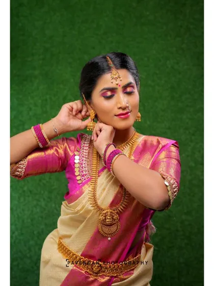Capturing candid moments is part of a great portfolio. This shot shows the detail of the makeup and hair as the model adjusts her jhumka, demonstrating how the look holds up from every angle.