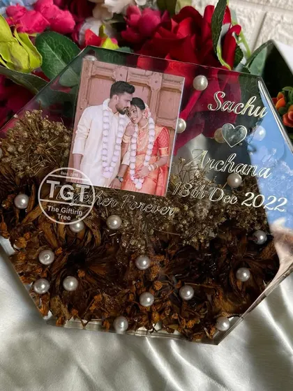 An angled view showing the thickness of the resin block and the beautiful arrangement of the lotus flowers and pearls inside.
