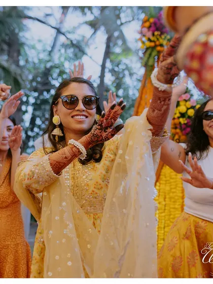 The bride leading her crew on the dance floor at the Haldi party.