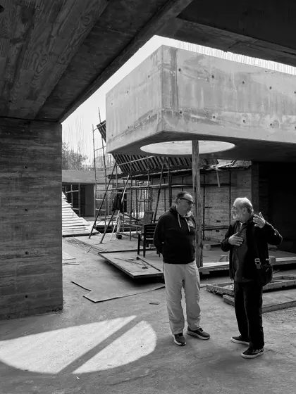 A discussion on-site at the Moradabad project. Here, I am explaining a design detail next to a large concrete volume with a circular cutout.