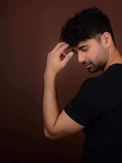 An introspective and dramatic pose for an actor's portfolio. This demonstrates emotional range and the ability to convey a story without words.