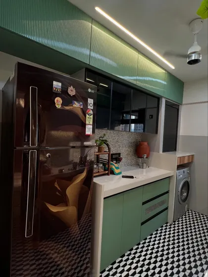 A practical corner of the kitchen, showing how appliances like the refrigerator and washing machine are neatly integrated into the design.