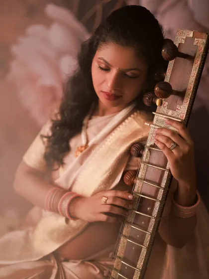 A serene moment with her sitar. This portrait is a beautiful blend of her passion for music and the magic of her maternity journey, creating something truly unique and personal.