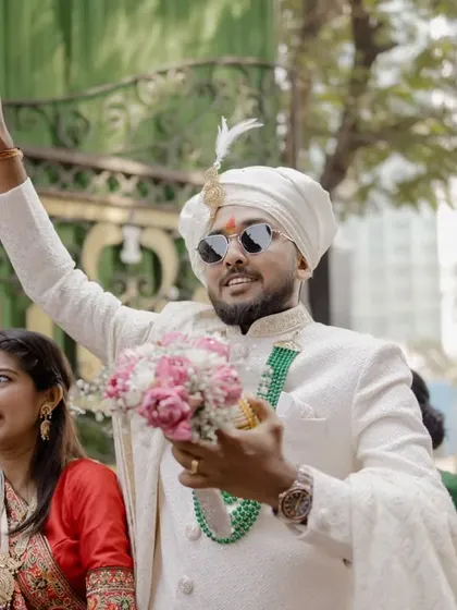 The groom's energetic arrival at the wedding venue, ready for the celebration.
