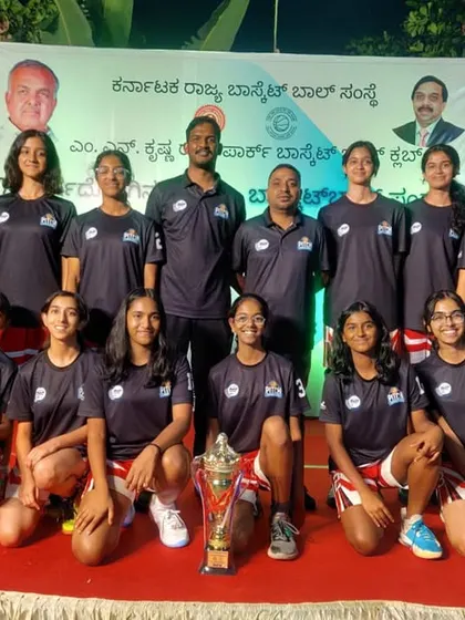 Our U16 girls team posing with their trophy and coaches at the State Championship awards ceremony.