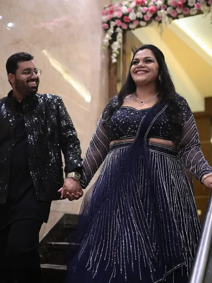 A happy couple ready for their event. Her makeup is glamorous and radiant, designed to look stunning both in person and in photos.