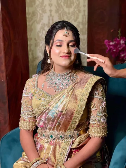 A behind-the-scenes look at the bride getting ready. Her beautiful smile and stunning ensemble are simply captivating.