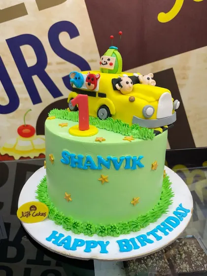 A 2.5kg Cocomelon cake with the iconic yellow bus and animal friends for a first birthday.