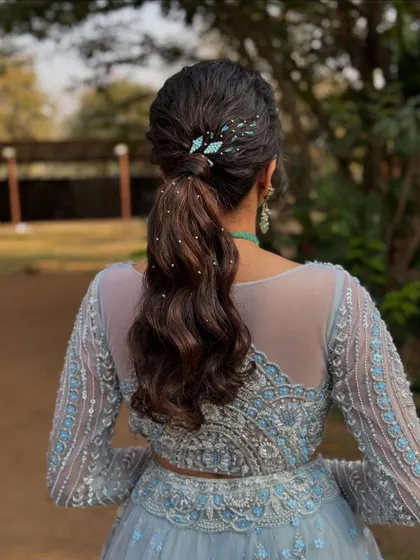 The ponytail captured outdoors, showing how the style looks beautiful in natural light. It's a versatile look for any modern celebration.
