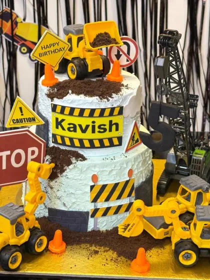 This two-tier construction site cake was so much fun to build. It's perfect for little ones who love trucks and features edible dirt, traffic signs, and multiple toy excavators and bulldozers for a busy, playful look.