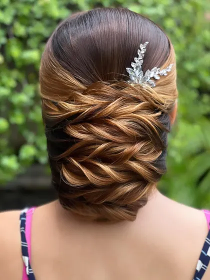 A close-up of the beautiful weaving technique used in this low bun, a key skill taught in my advanced course.