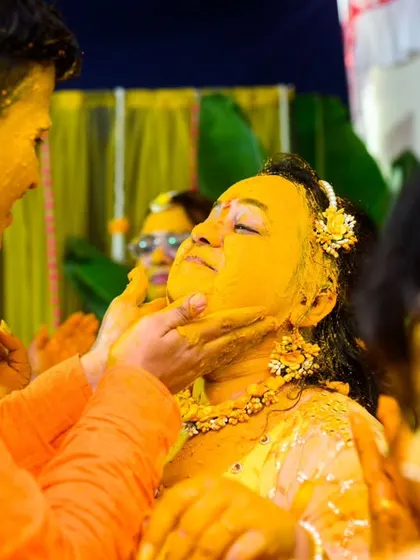 A close up of the haldi application. This is a classic shot, but the genuine expressions make it special.