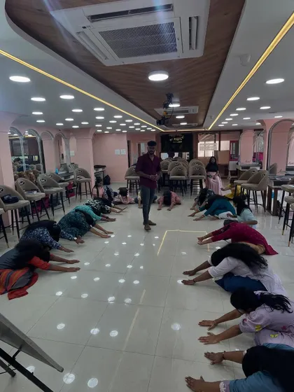 Students participating in a stretching session to help with back pain, a common issue for makeup artists. *Idupellam confirm kalandhurum* if you don't take care!