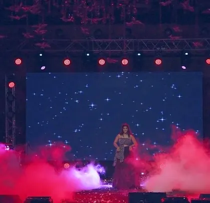 A stunning silhouette of the performer against a starry backdrop. This shot captures the beauty and emotion of the sister's solo.