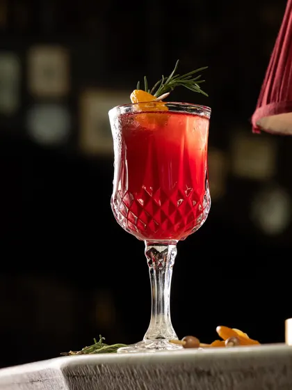 A symphony of flavors in every glass. This deep red cocktail, served in an ornate crystal glass, is the essence of indulgence.
