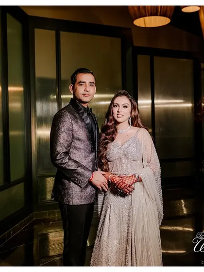 A classic, elegant portrait of the couple at their Sangeet in Goa, looking sharp and sophisticated.