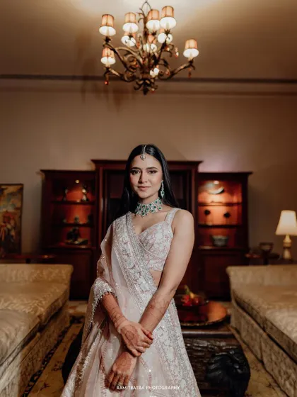 A classic portrait of the bride in her elegant Manish Malhotra engagement lehenga at Rambagh Palace.