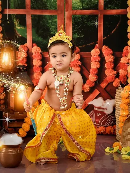A magical moment with our little Krishna. The sparkling lights and smoke effect add a touch of divine mystery to the portrait.