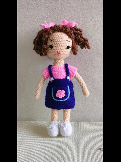 I love making curly hair for my dolls. This one has beautiful brown curls and a cute denim-style dress. Her shoes can be taken off too.