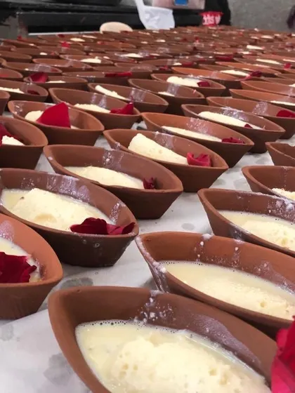 My dessert stations are filled with treats like these creamy sweets served in traditional earthen pots, or matkas. This photo shows our large-scale preparation for an event, where each dessert is carefully prepared and garnished with a rose petal for a beautiful presentation.