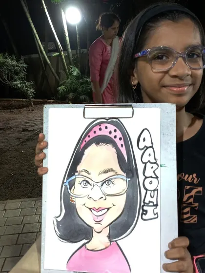 This young guest named Aarohi was very pleased with her colorful caricature. I often use watercolor to add a vibrant touch to my black and white line drawings.