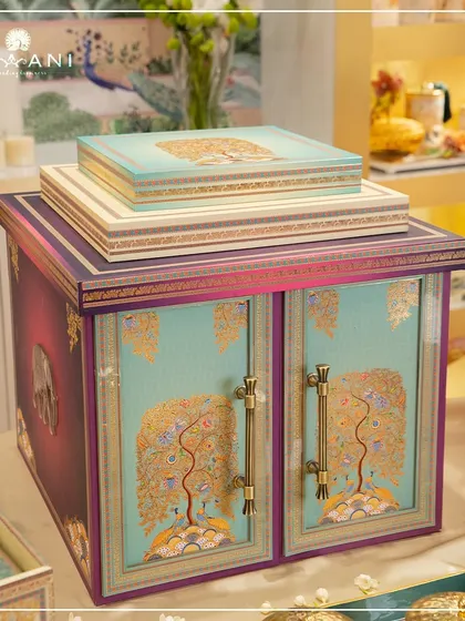 This Tree of Life wedding hamper is a masterpiece of heritage design. The cabinet-style box, featuring peacock and elephant motifs, is a testament to my love for creating personalized gifts that carry deep symbolic meaning.