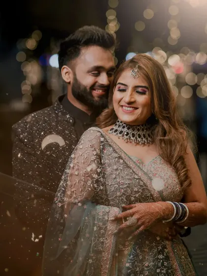 A happy and intimate portrait of the couple during their engagement party, with beautiful bokeh lights in the background.