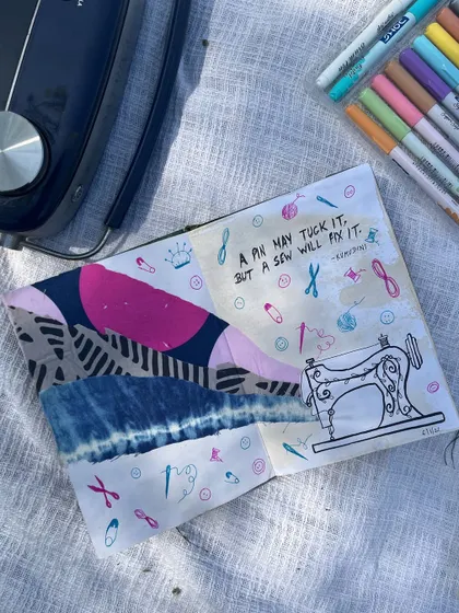A sewing-themed journal page using fabric scraps and doodles. The quote reads, "A pin may tuck it, but a sew will fix it."