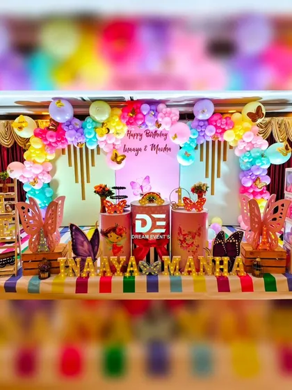A bright and cheerful butterfly theme for twins Inaaya and Manha. I used a rainbow of pastel balloons, a striped tablecloth, and gold marquee letters to make their first birthday extra special.