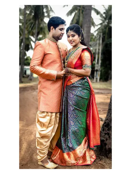 A full-length outdoor portrait of the traditionally dressed couple, a timeless memory from their engagement day.