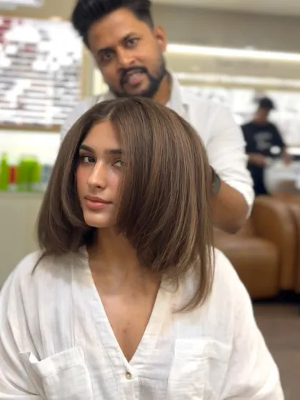 A beautiful brunette brown color on a shorter, chic bob. This look is modern, stylish, and shows that brown is anything but boring.
