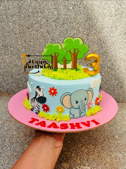 A cute animal theme cake with a friendly elephant and zebra. I used buttercream grass and edible toppers to create a sweet little safari scene.