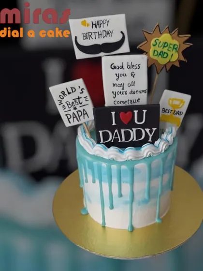 A sweet and simple drip cake with toppers celebrating the "World's Best Papa." This is a wonderful way to show appreciation for a super dad on his birthday.