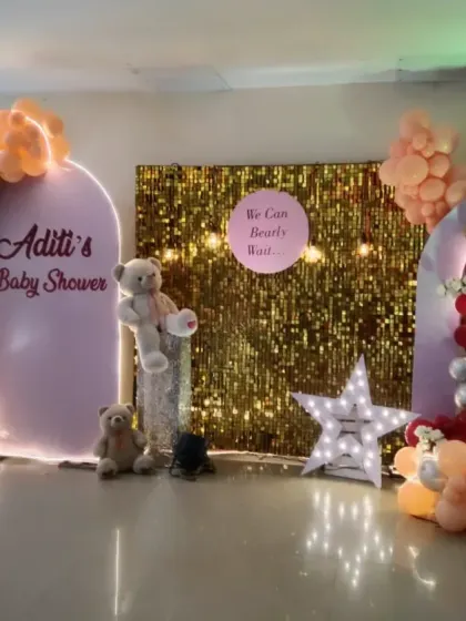 A glamorous baby shower for Aditi with the fun message "We Can Bearly Wait". This design combines a gold sequin backdrop with pink, red, and gold balloons and cute teddy bears.
