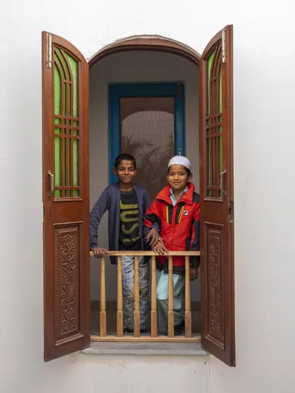For me, architecture is about creating spaces for people. Here, two young residents of the Butterflies Resilience Centre look out from a 'jharokha' window made from upcycled shutters. These small moments of joy are the true measure of a successful building.