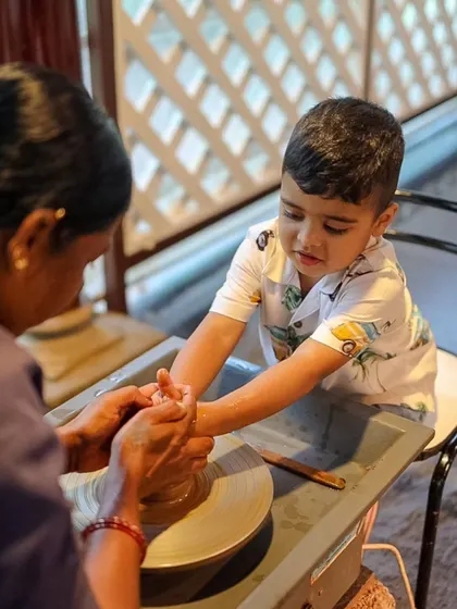 A young boy learns the basics of pottery with the help of our instructor. We love providing a space where kids can explore their creativity and learn new skills.