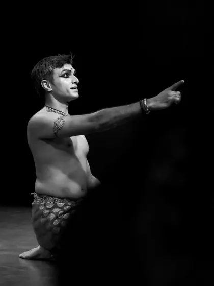 A black and white image of me in 'ATAH', pointing towards an unseen focus. This gesture creates a sense of narrative and direction in the dance.