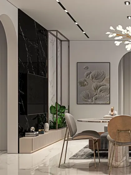 A bold statement is made with this black marble TV wall, beautifully contrasted with a light-colored dining area. Arched doorways add a soft, classic touch to the modern design.