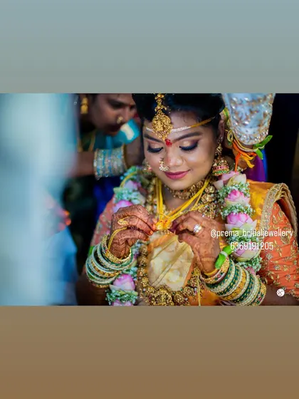 A close-up of the bride during the rituals, with her jewellery taking center stage.