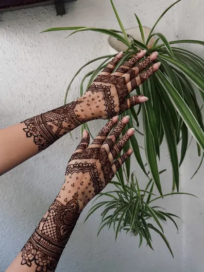 A modern take on bridal mehndi, this design features geometric chevrons and delicate dot work, creating a lighter, more contemporary feel.