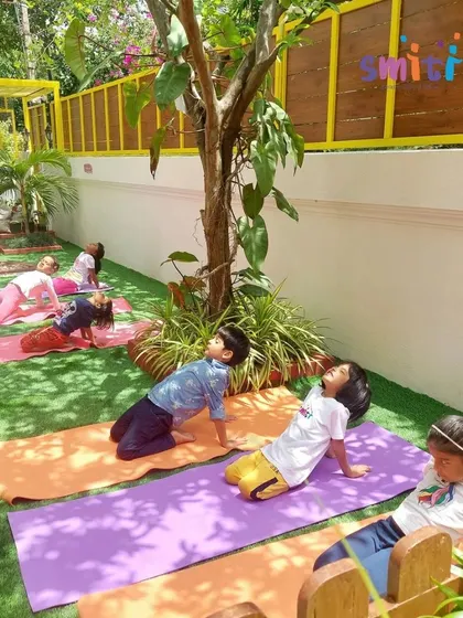 Children in our garden doing the camel pose. The outdoor setting makes our yoga sessions a refreshing experience.