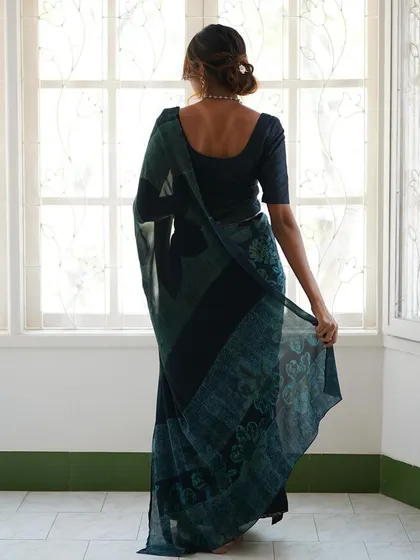 This is our hero item. The Nilā saree embodies our craft. It is a deep indigo silk georgette piece that took over 60 hours to create, combining intricate textures and custom-carved floral motifs using a specialized discharge printing technique.