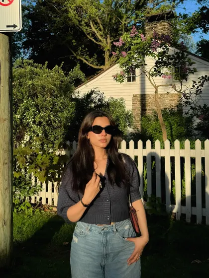 Modeling a casual and cute navy blue top from Nykd by Nykaa in a sunny, picturesque setting.